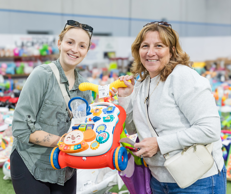 A group of shoppers wearing masks for safety reasons gathers together at the sale to shop.